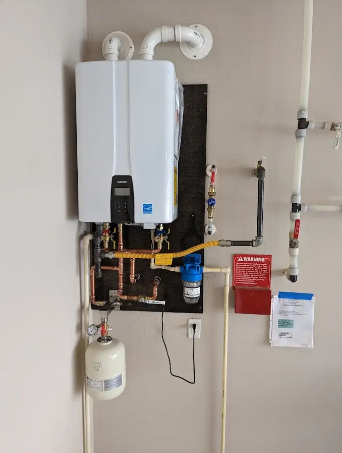 Professional plumber installing copper piping in a Bluffdale home